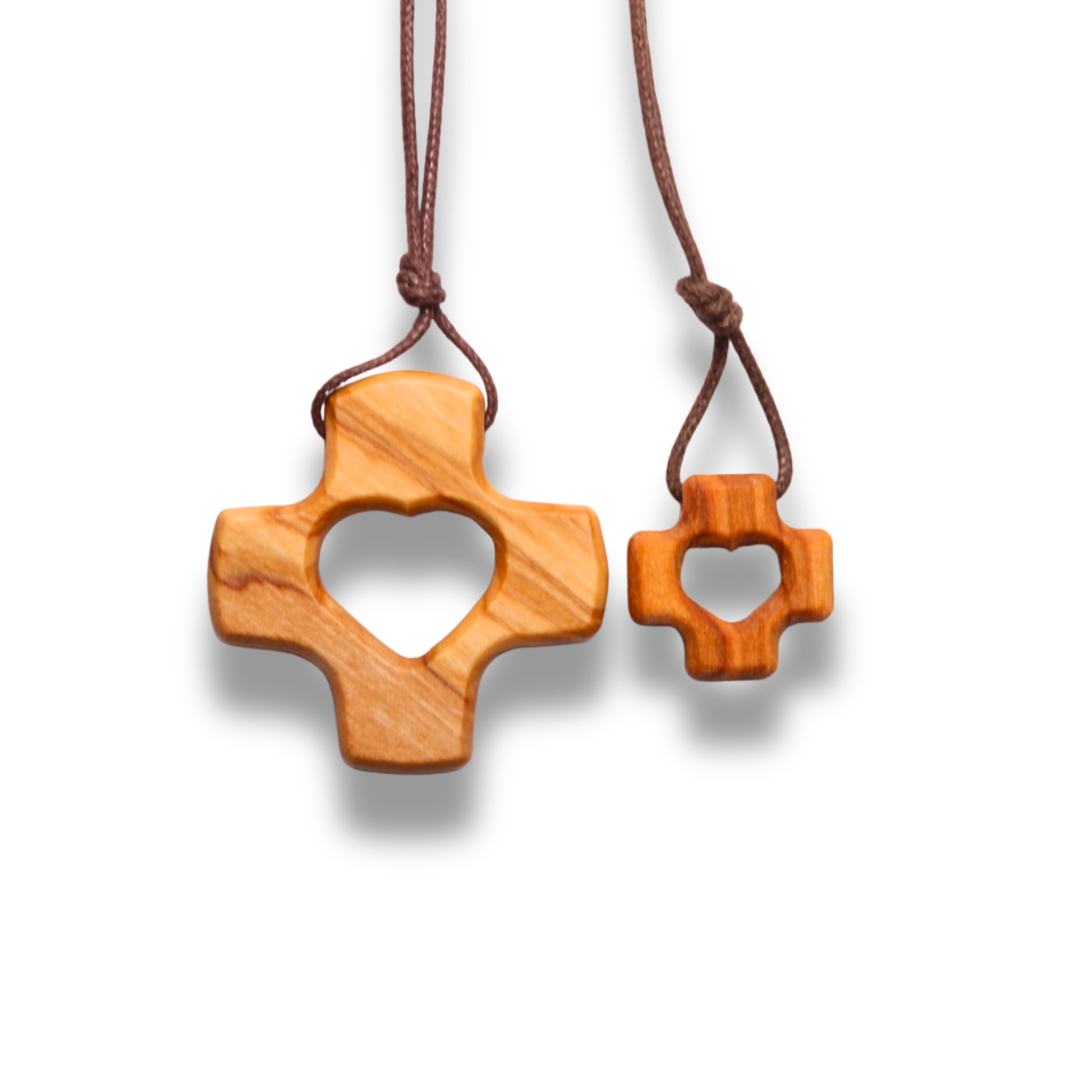 Two Olive wood crosses pendants with heart cutout on a white background
