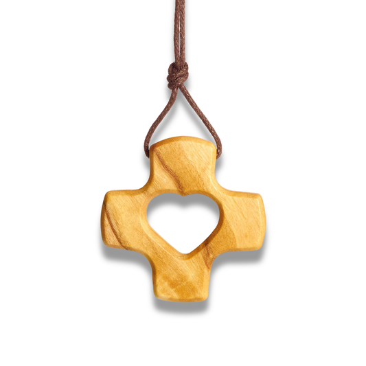 Olive wood cross pendant with heart cutout on a white background