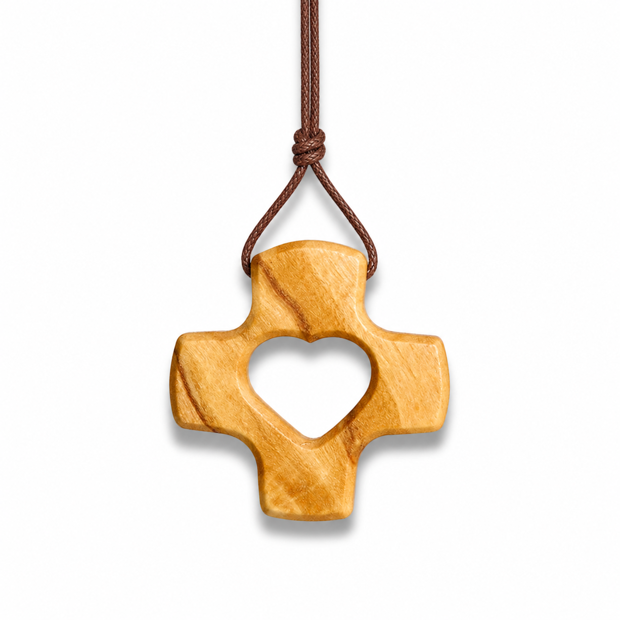 Wooden cross pendant with heart cutout on a white background