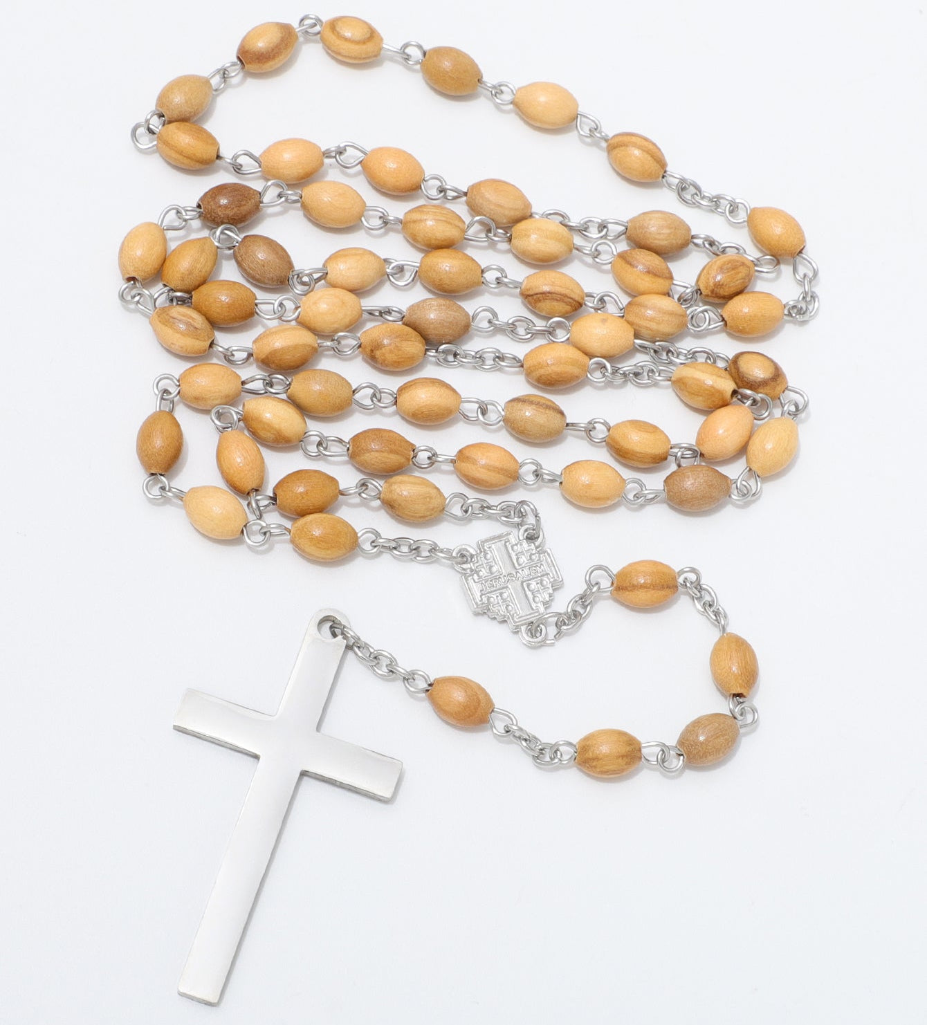 A wooden bead rosary necklace with light brown oval beads, silver chain links, and a polished silver cross pendant, displayed on a clean white background.