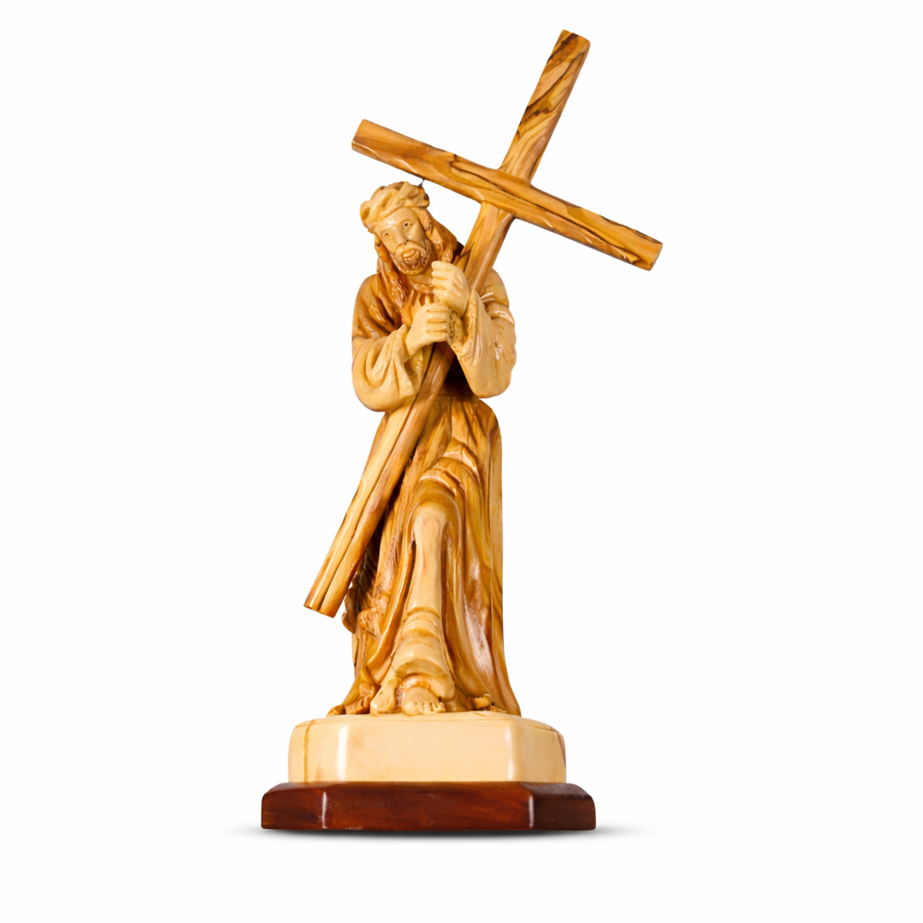 Wooden statue of a Jesus carrying the cross on a white background