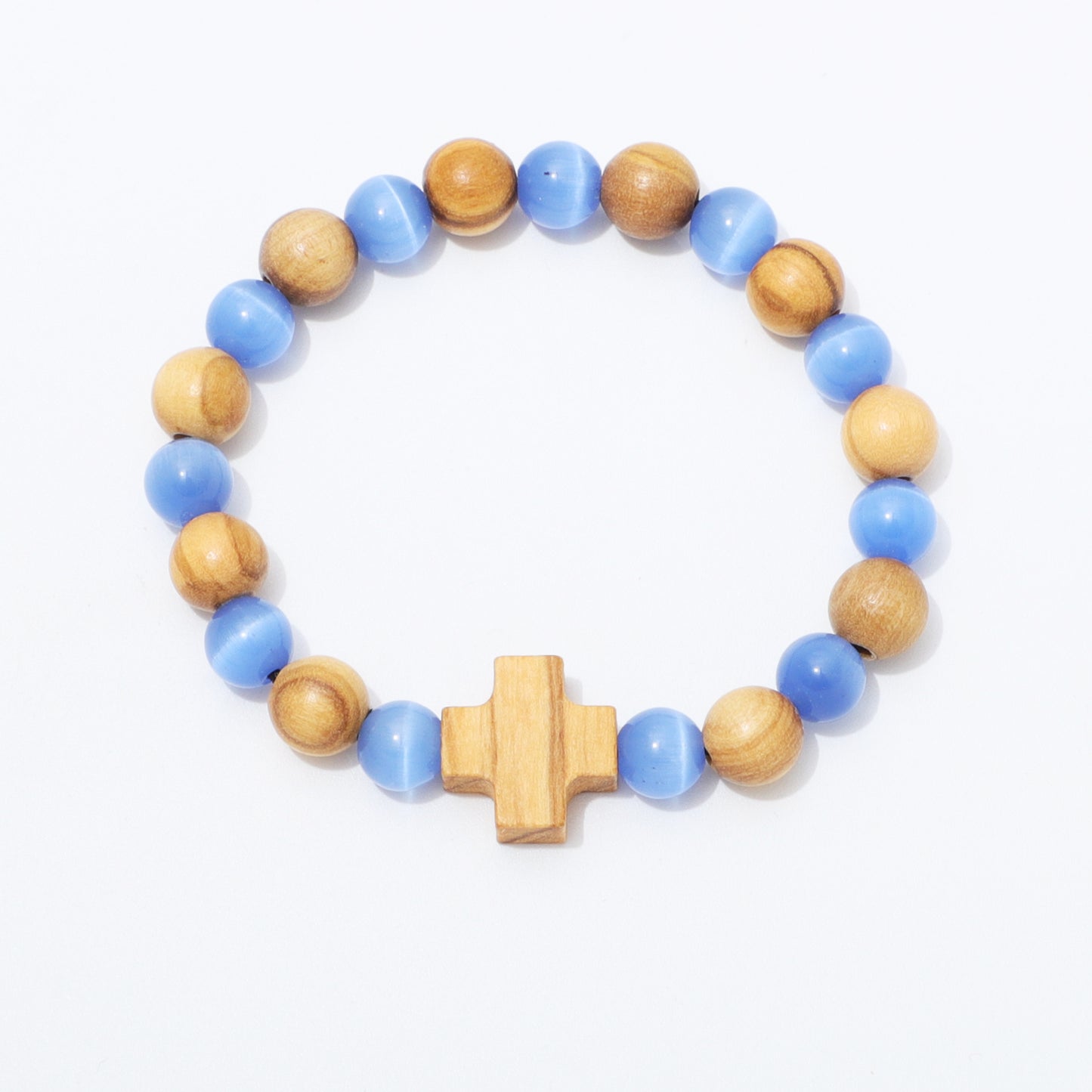 A beaded stretch bracelet featuring alternating light blue and natural wood beads, finished with a central wooden cross charm, shown on a plain white background.