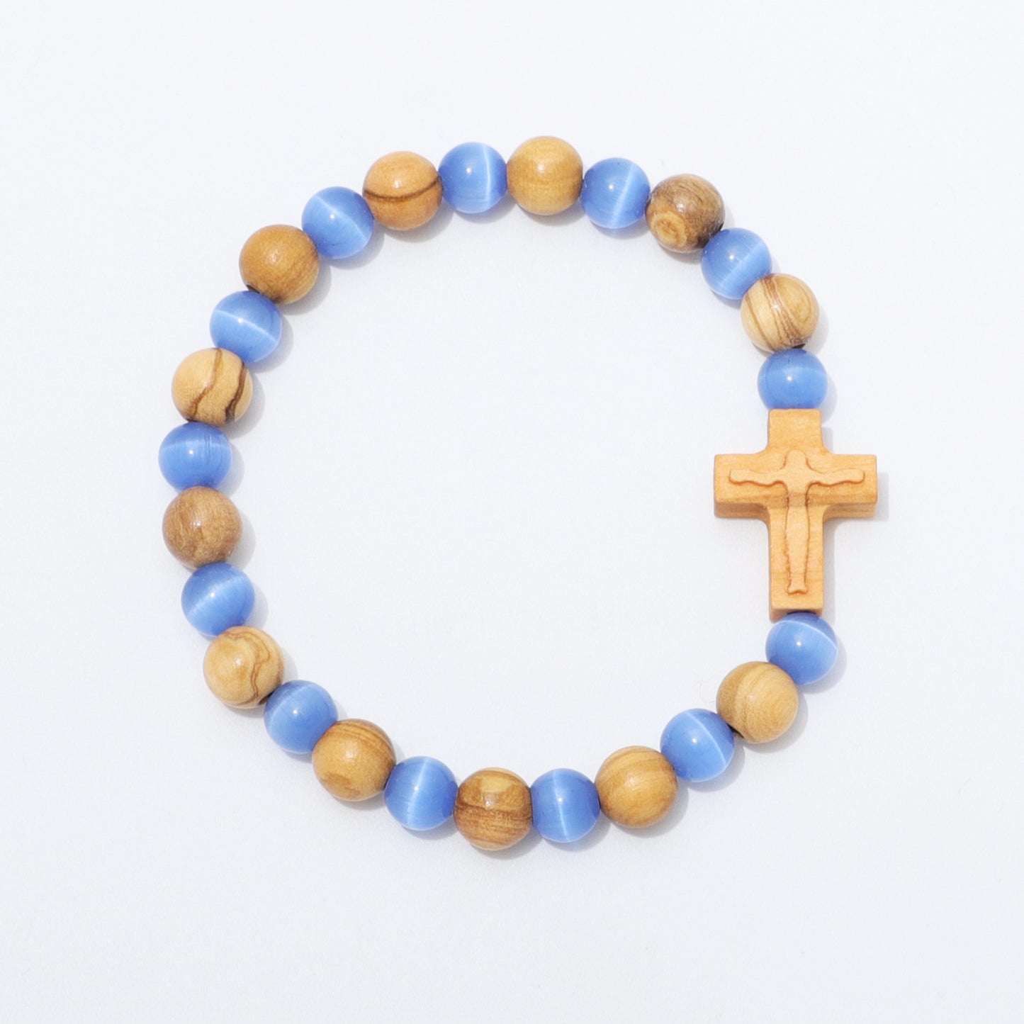 A beaded rosary-style bracelet featuring alternating light blue and natural wood beads, with a small wooden crucifix at the end, displayed on a clean white background.