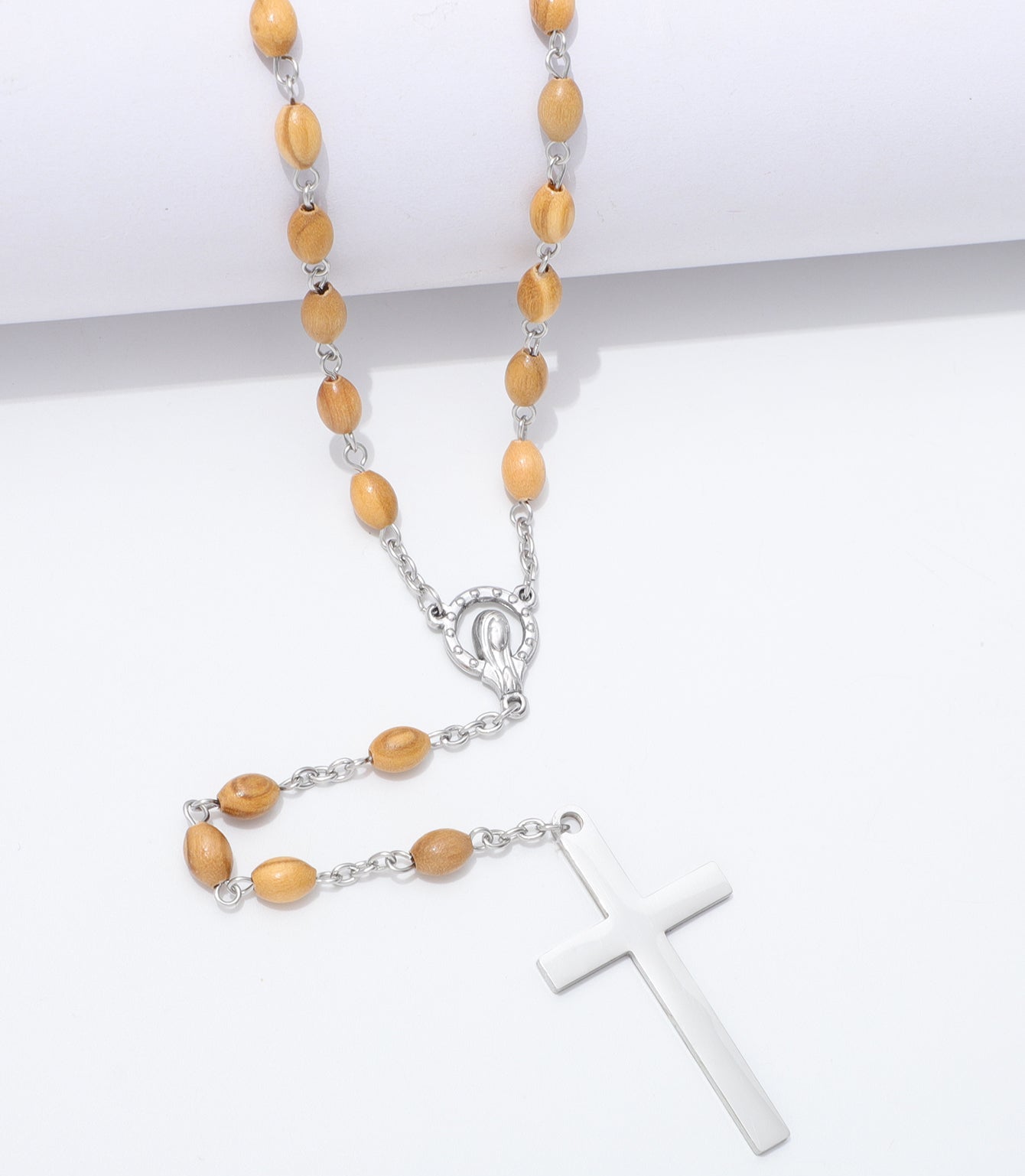 A rosary necklace with light brown wooden beads