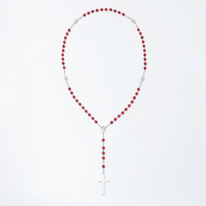 A red and silver beaded rosary necklace with a silver cross pendant, displayed against a clean white background.