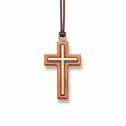 Wooden cross pendant with a brown cord on a white background
