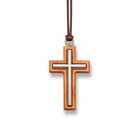 Wooden cross pendant with a brown cord on a white background