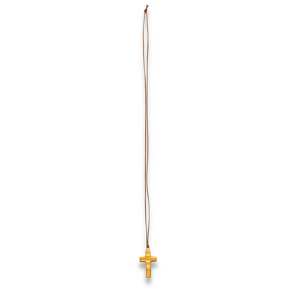 Olive wood cross pendant against a white background