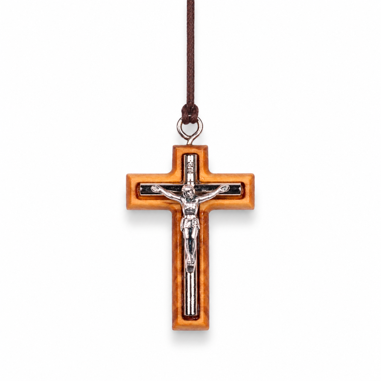 Wooden cross pendant with silver colored Jesus figure on a white background