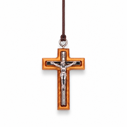 Wooden cross pendant with silver colored Jesus figure on a white background
