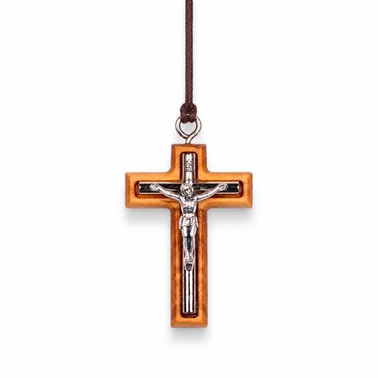 Wooden cross pendant with silver colored Jesus figure on a white background