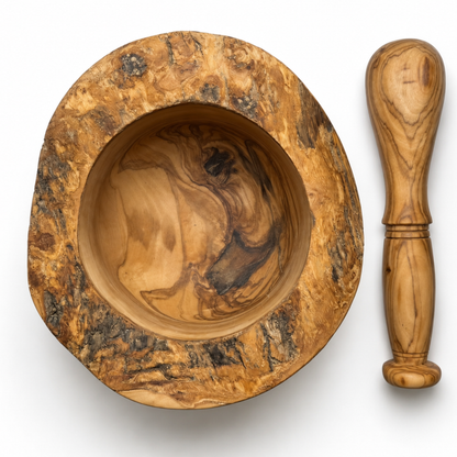 A handcrafted wooden mortar and pestle set on a white background. The mortar features a rustic, heavily textured outer rim with swirling patterns of tan, brown, and black wood grain, while the pestle has a smoother, polished light-brown wood handle.