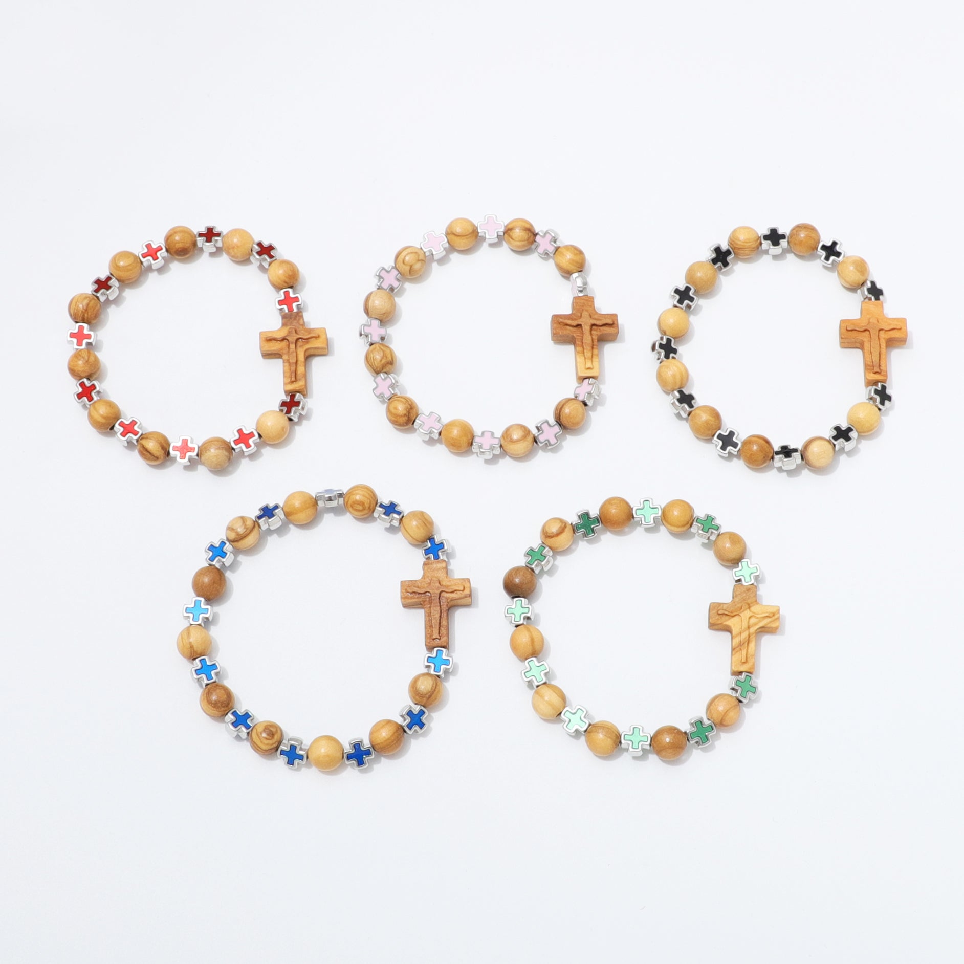 Five wooden bead bracelets with wooden cross charms and colorful star beads, arranged on a plain white background.