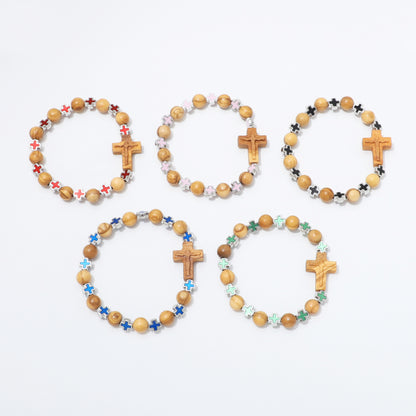 Five wooden bead bracelets with wooden cross charms and colorful star beads, arranged on a plain white background.
