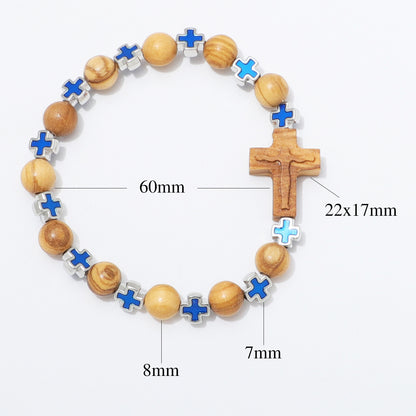 A beaded bracelet with wooden beads, blue enamel crosses, and a wooden crucifix, shown on a white background with measurement labels indicating 60mm total length, 22x17mm crucifix size, 8mm bead size, and 7mm cross accent size.