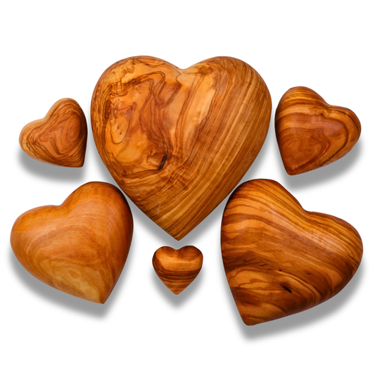 Set of olive wood heart shapes on a white background