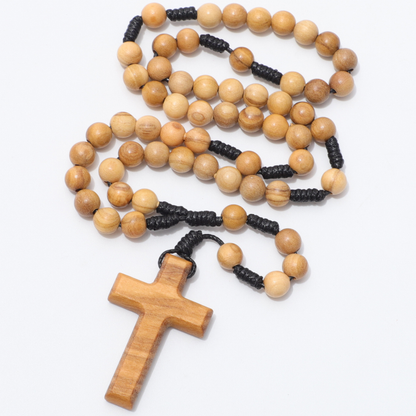 Wooden rosary with a cross on a white background