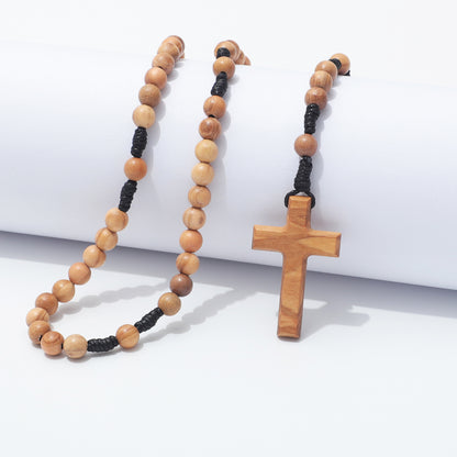 A wooden bead rosary necklace with a matching wooden cross pendant, displayed on a clean white background.