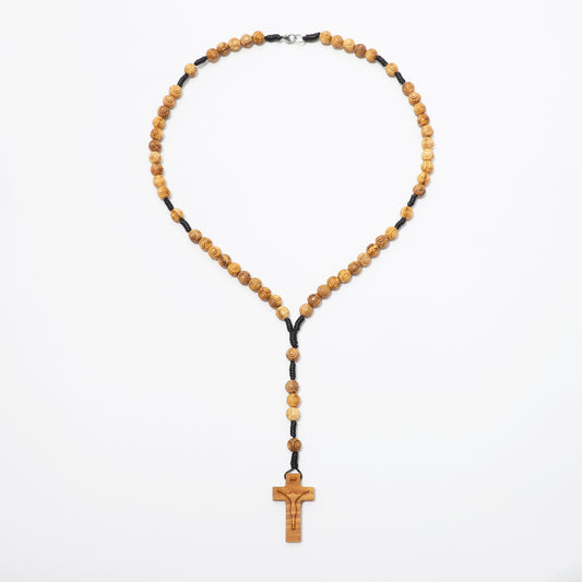 Engraved olive wood rosary necklace with 8mm beads laid out on a white background