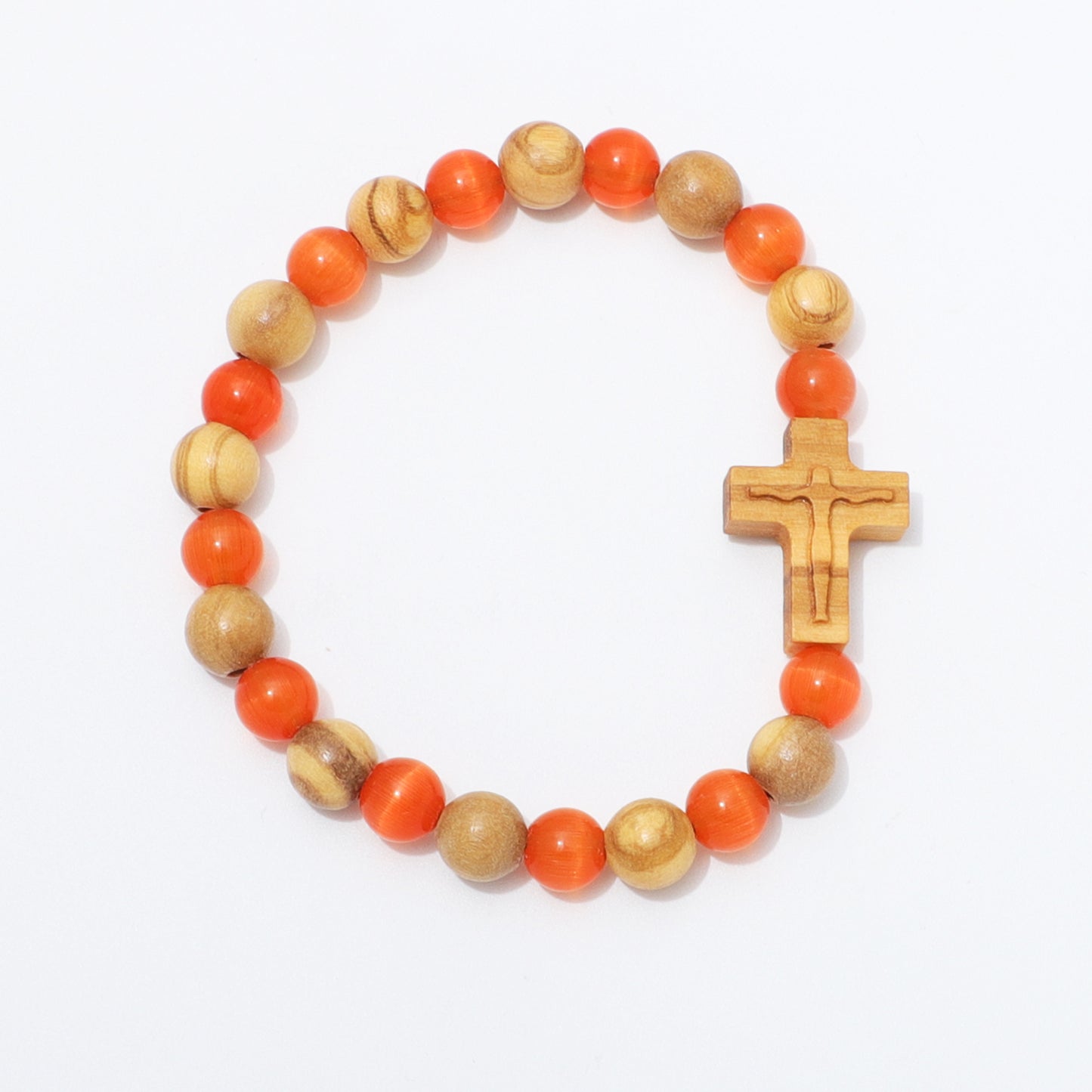 A beaded bracelet featuring alternating round orange beads and natural light wood beads, with a small carved wooden cross at the front, photographed on a clean white background.