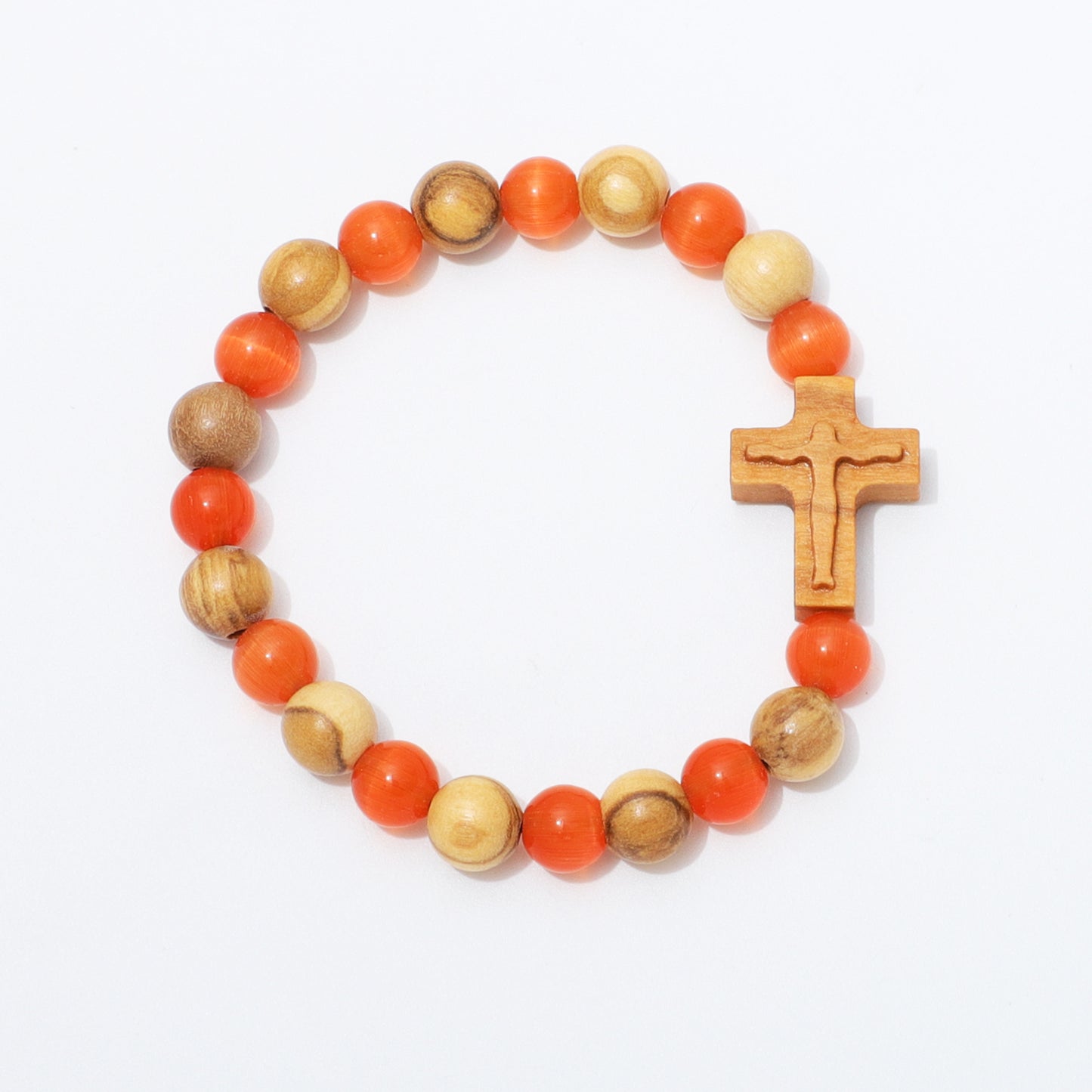 A beaded rosary-style bracelet with alternating orange and natural wood beads, featuring a carved wooden cross charm, photographed on a clean white background.