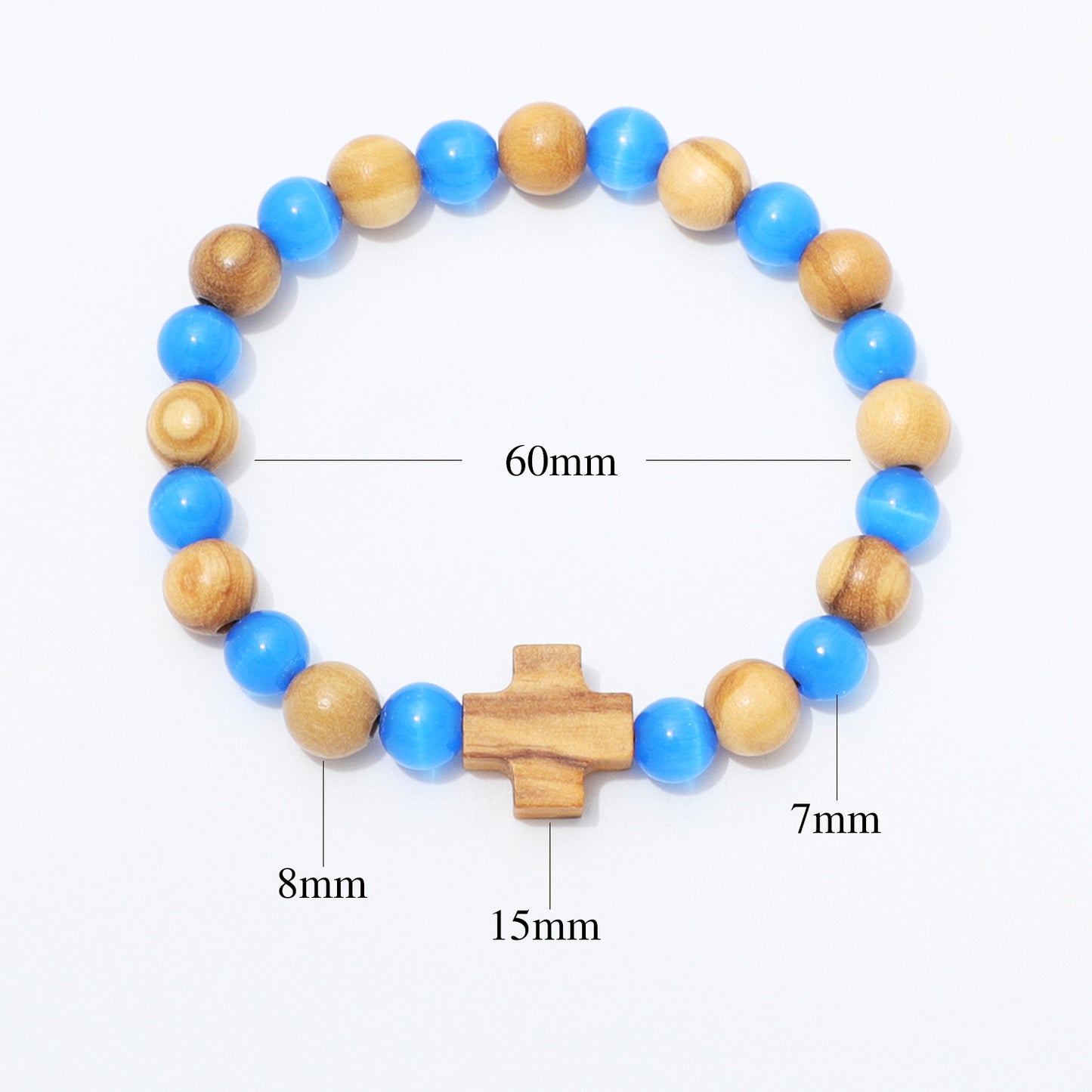 A beaded bracelet with alternating light brown wood beads and bright blue beads, featuring a central wooden cross charm. White measurement lines and text labels indicate dimensions: 60mm for the overall bracelet size, 15mm for the central cross, 8mm for some beads, and 7mm for others, on a plain white background.