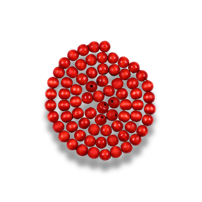 Red beads arranged in a circular pattern on a white background