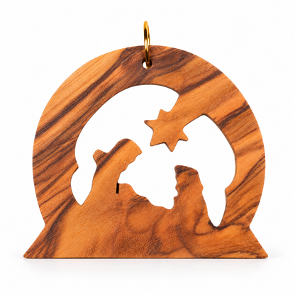 A handcrafted olive wood ornament featuring a nativity scene silhouette with a star, hanging from a gold metal loop on a white background.
