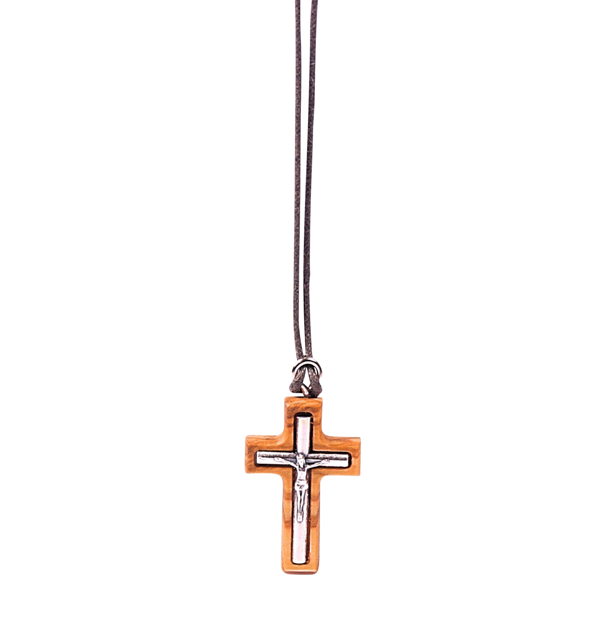 A minimalistic olive wood crucifix pendant with a perfectly embedded silver-toned metal depiction of Jesus, hanging from a soft cotton cord.