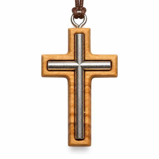 A wooden cross pendant necklace with a polished silver metal center and a brown cord, shown on a plain white background.