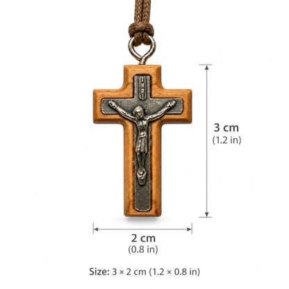 A wooden crucifix pendant with a metal corpus and hanging cord, shown on a white background with dimension labels indicating 3 cm height and 2 cm width.
