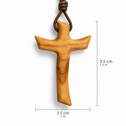 A wooden cross pendant with a brown braided cord, shown on a white background with dimension lines indicating a height of 3.5 cm (1.