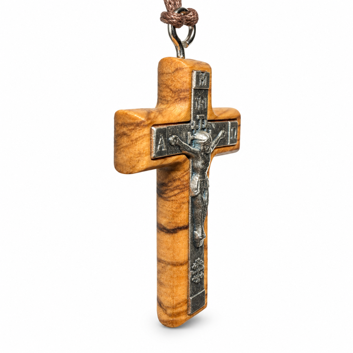 A wooden crucifix pendant necklace made of warm-toned olive wood with a dark metal corpus and a knotted brown cord, shown on a plain white background.