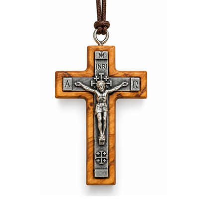 An olive wood and silver-tone metal crucifix pendant with a detailed corpus of Jesus Christ, hanging from a brown cord on a white background.