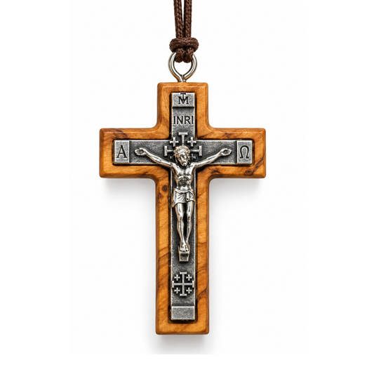 An olive wood and silver-tone metal crucifix pendant with a detailed corpus of Jesus Christ, hanging from a brown cord on a white background.