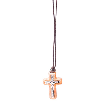 Olive wood crucifix pendant with a silver-tone metal depiction of Jesus, accompanied by an 'INRI' sign at the top, suspended from a soft cotton cord.