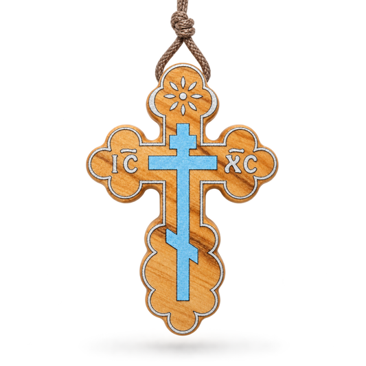 A wooden Orthodox cross ornament with a light blue enamel cross in the center, featuring the Greek letters ΑΦ and ΧΦ, on a white background.