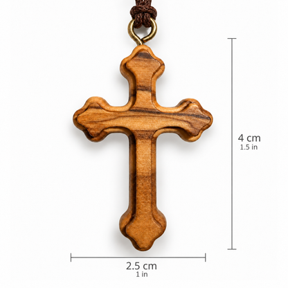 A wooden Orthodox cross pendant with a natural grain pattern, hanging from a dark brown cord with a brass ring. The image includes dimension overlays showing the height as 4 cm (1.