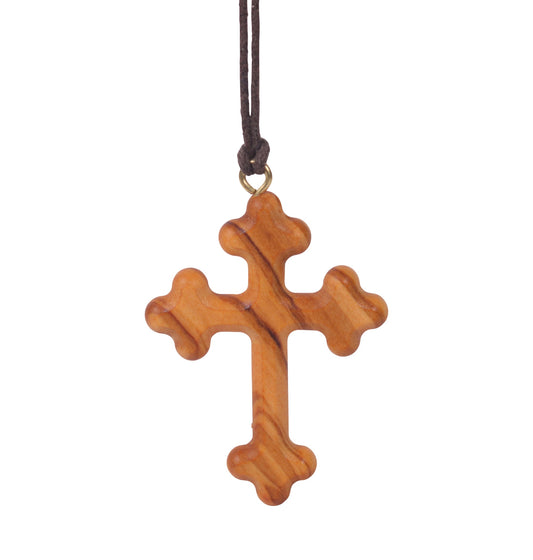 Olive wood orthodox cross pendant with three rounded protrusions on each arm, suspended from a soft cotton cord.