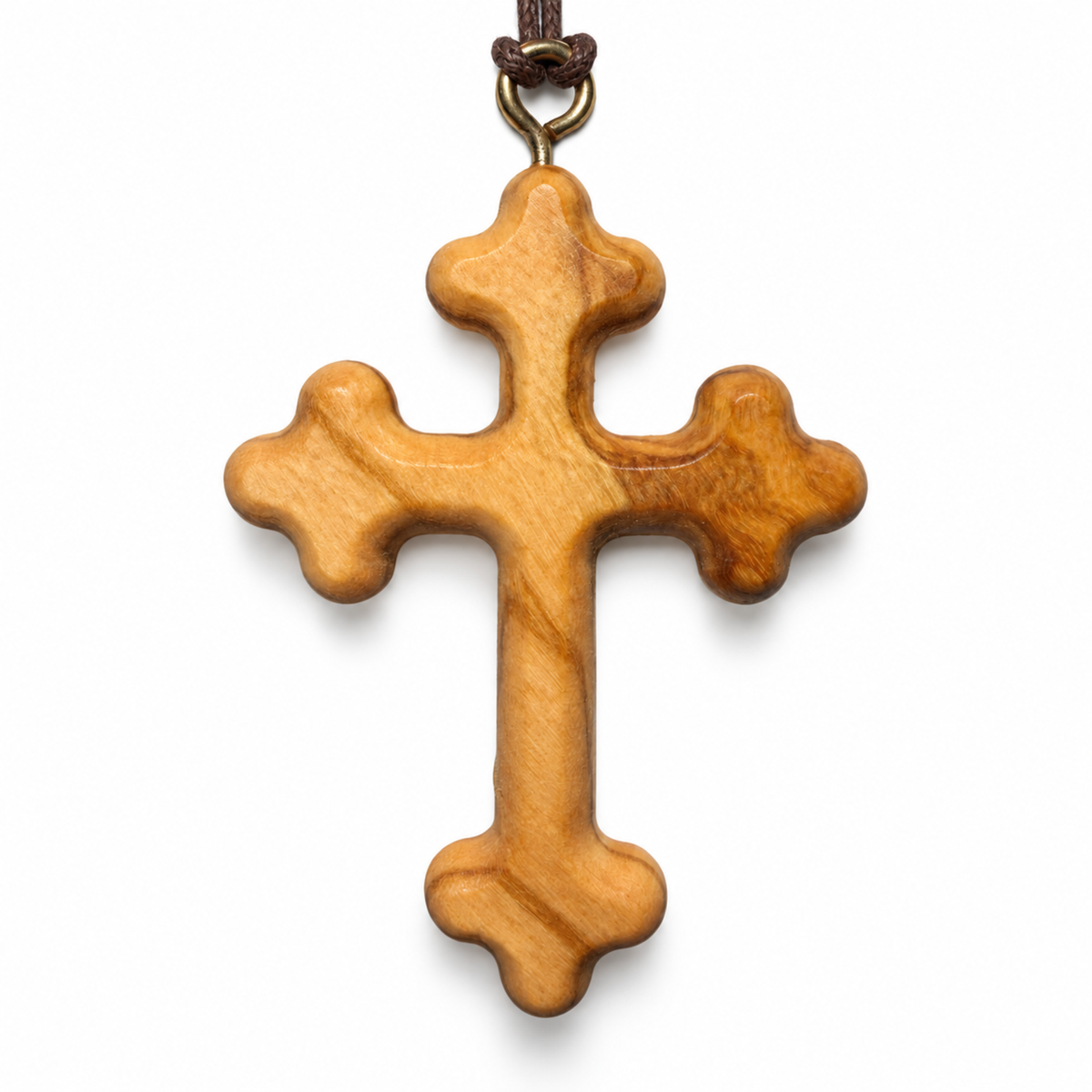 A carved olive wood cross pendant with a natural grain pattern, hanging from a dark brown cord and brass ring against a white background.