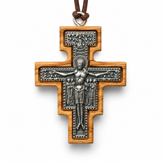 A wooden Orthodox cross pendant featuring an embossed silver-toned metal crucifix with a brown cord loop at the top, shown on a clean white background.