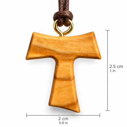 A wooden T-shaped pendant with a warm honey-brown finish and a gold-tone loop, hanging from a dark brown cord. Black dimension lines and text indicate a height of 2.5