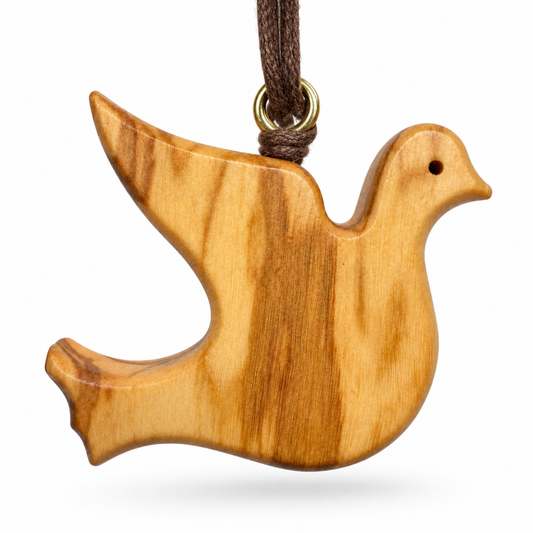 A wooden dove-shaped ornament with a natural light brown wood grain pattern, hanging from a dark brown cord with a brass ring, shown against a plain white background.