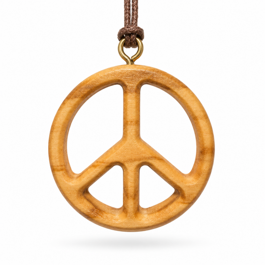 A wooden peace sign pendant necklace made from natural olive wood with a brown cord and brass ring, shown on a white background.