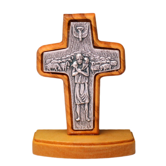 Olive Wood Cross captures Jesus as the Good Shepherd, blending olive wood and silver-toned metal. The detailed relief of Jesus with a lamb on his shoulders.