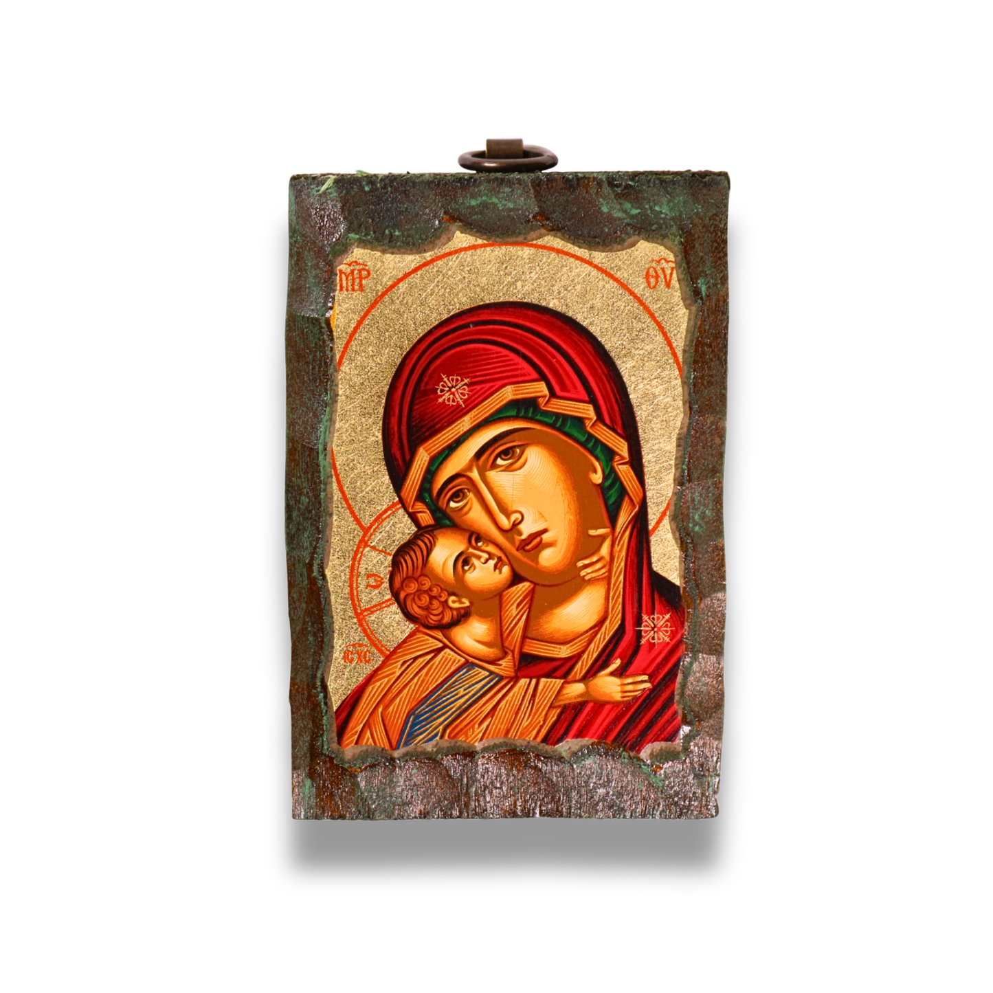 An icon of the Virgin Mary in a red robe holding the child Jesus, with both figures haloed against a gold leaf background. Above them are two angels, and the icon is bordered by a dark, textured frame with a metal loop at the top for hanging.