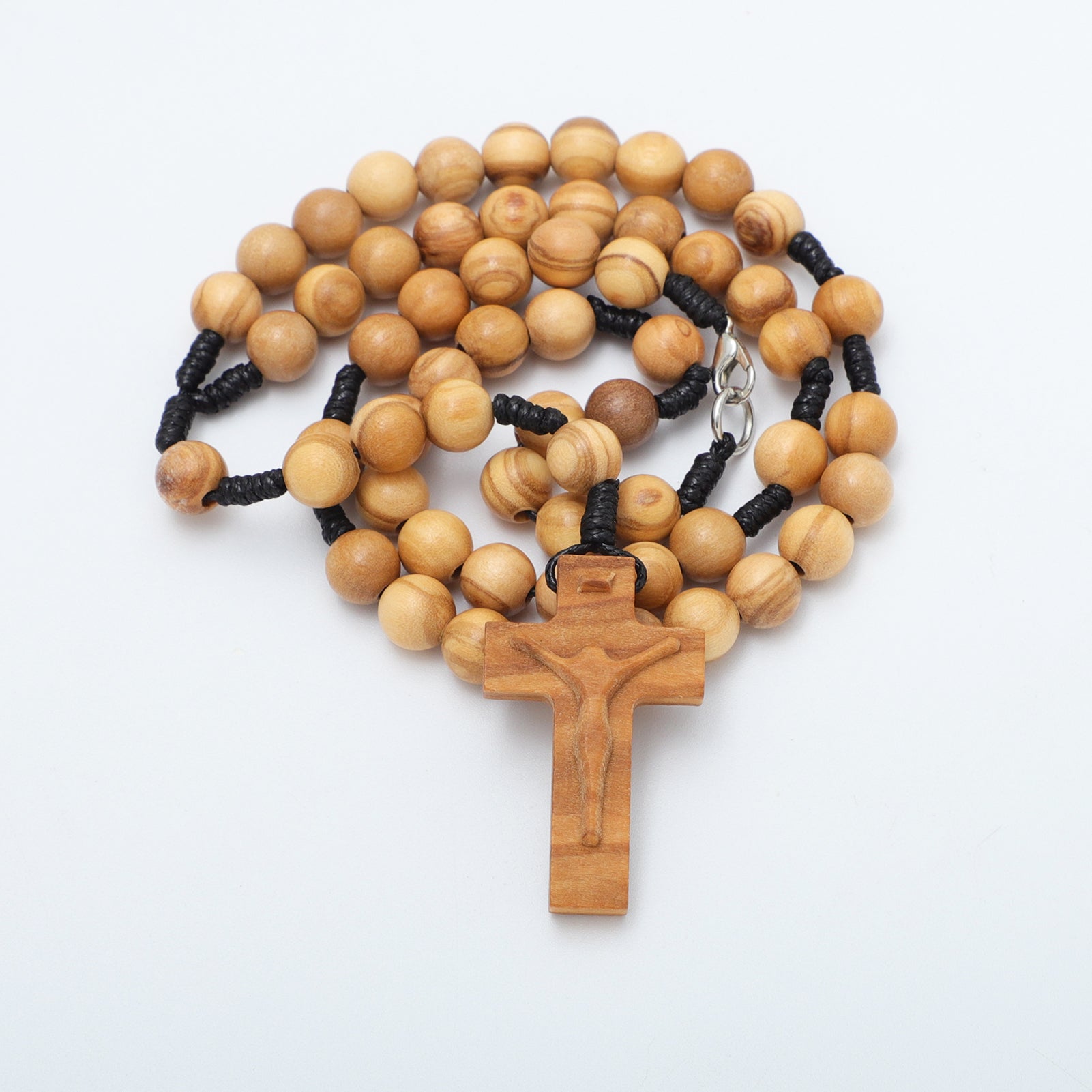 Wooden rosary with a cross on a white background