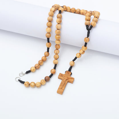 Wooden rosary with a cross on a white background