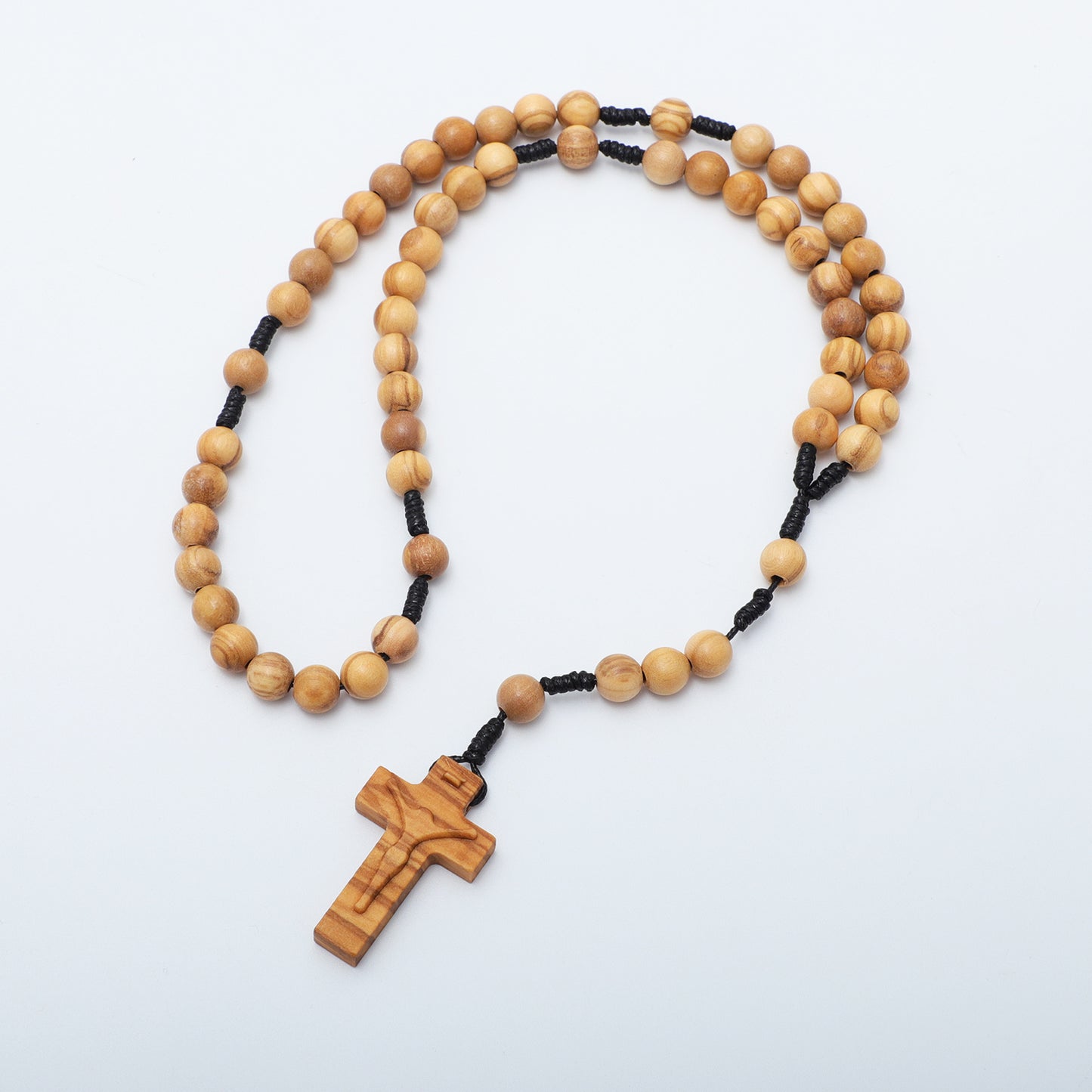 Wooden rosary with a cross on a white background