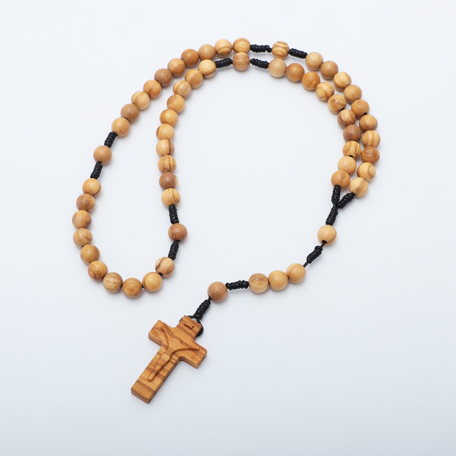 Wooden rosary with a cross on a white background